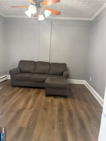 a view of a livingroom with furniture window and wooden floor