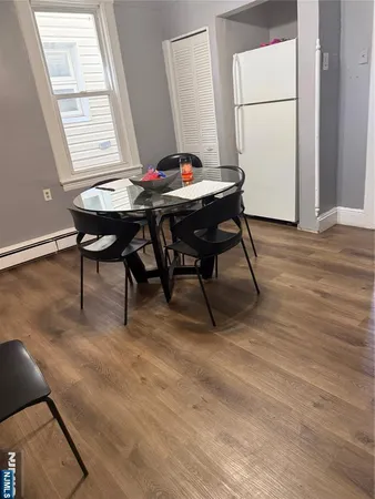 a view of a dining room with furniture and chandelier