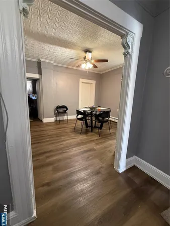 a view of a dining room with furniture and chandelier
