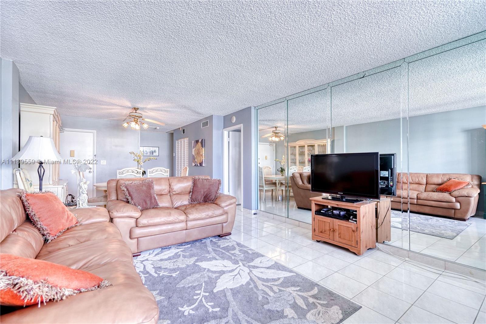 245 18th Street, Unit 602 Miami Beach, FL 33139 - Photo 11 of 40 a living room with furniture and a flat screen tv
