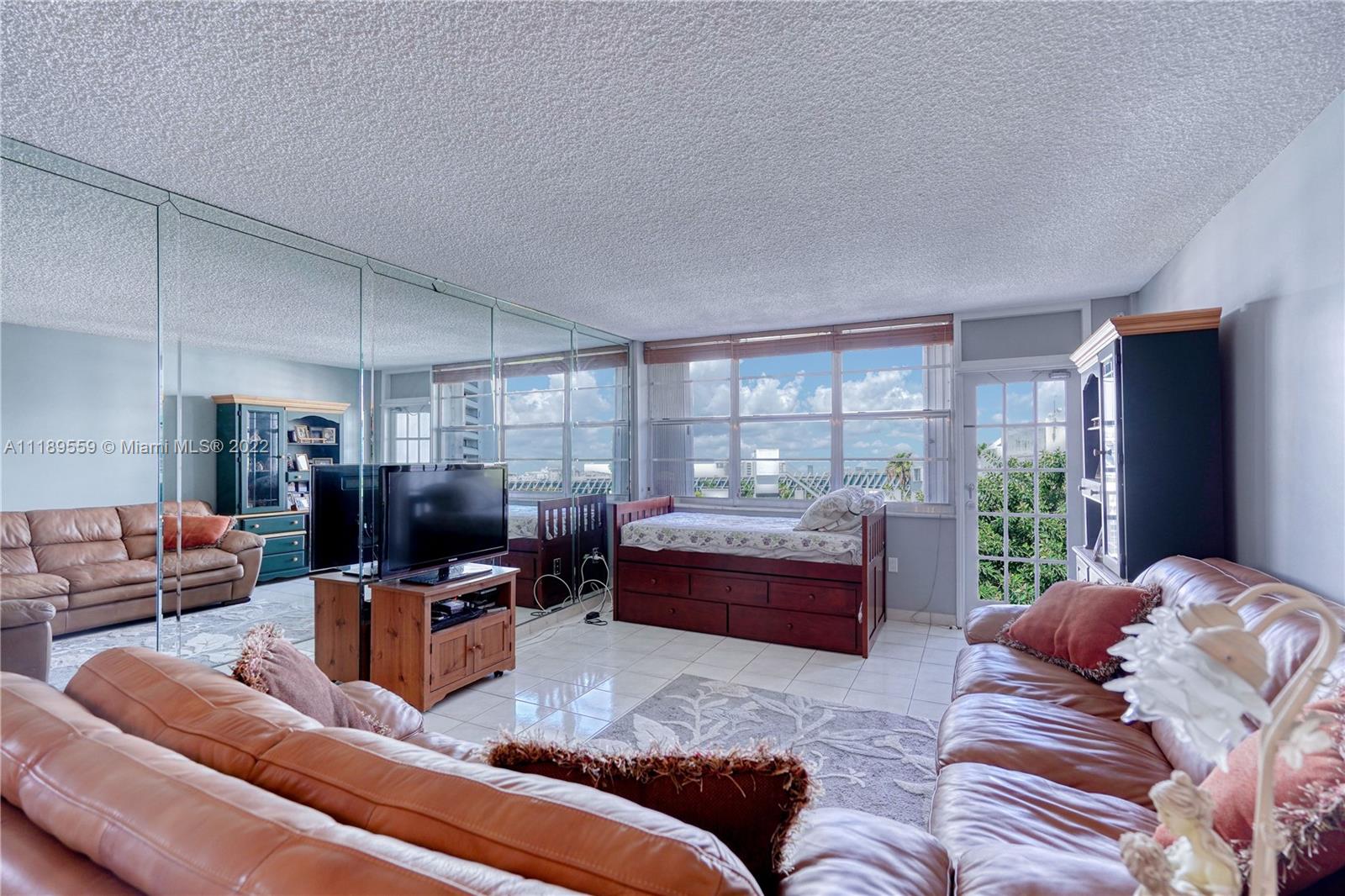 245 18th Street, Unit 602 Miami Beach, FL 33139 - Photo 12 of 40 a living room with furniture or couch and a window
