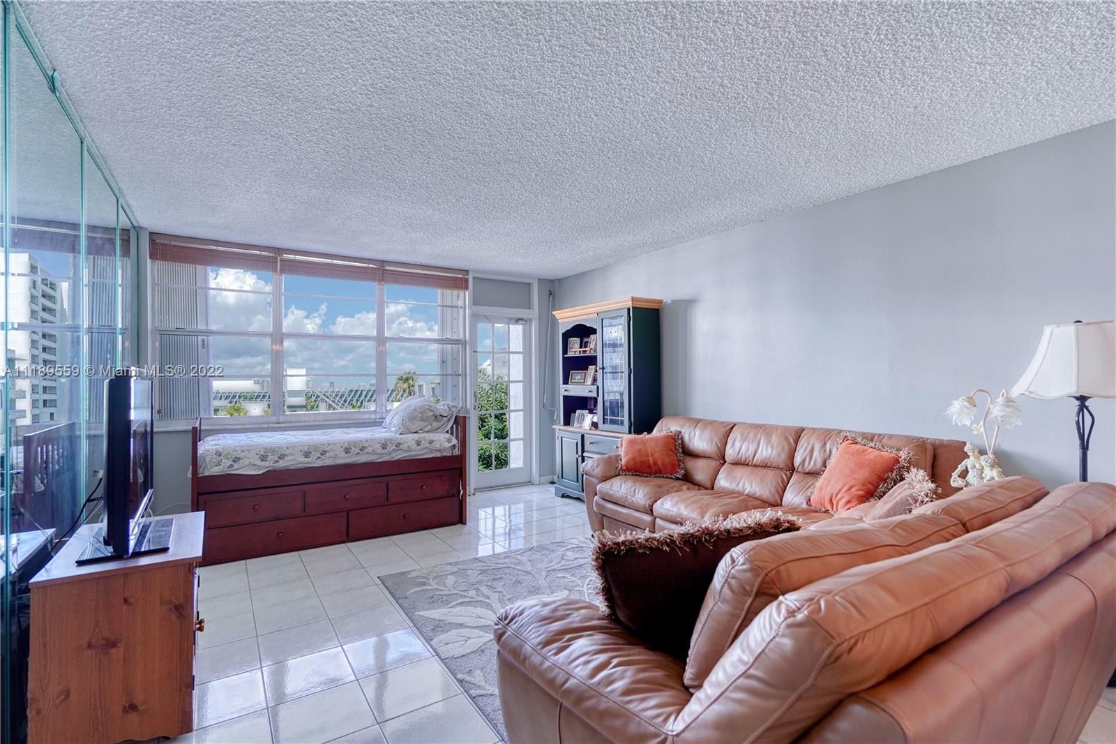 245 18th Street, Unit 602 Miami Beach, FL 33139 - Photo 13 of 40 a living room with furniture and a large window