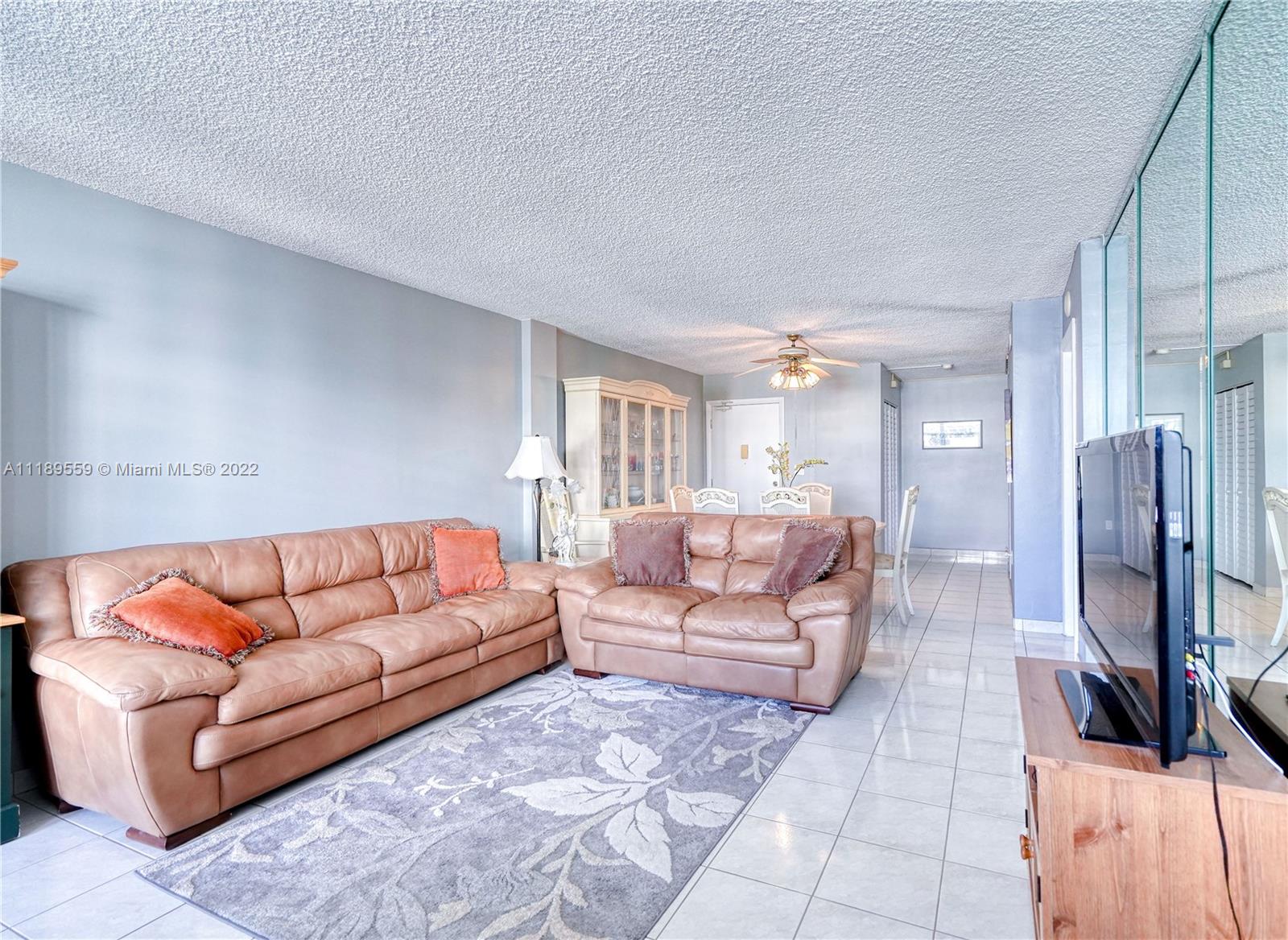 245 18th Street, Unit 602 Miami Beach, FL 33139 - Photo 14 of 40 a living room with furniture and a fireplace