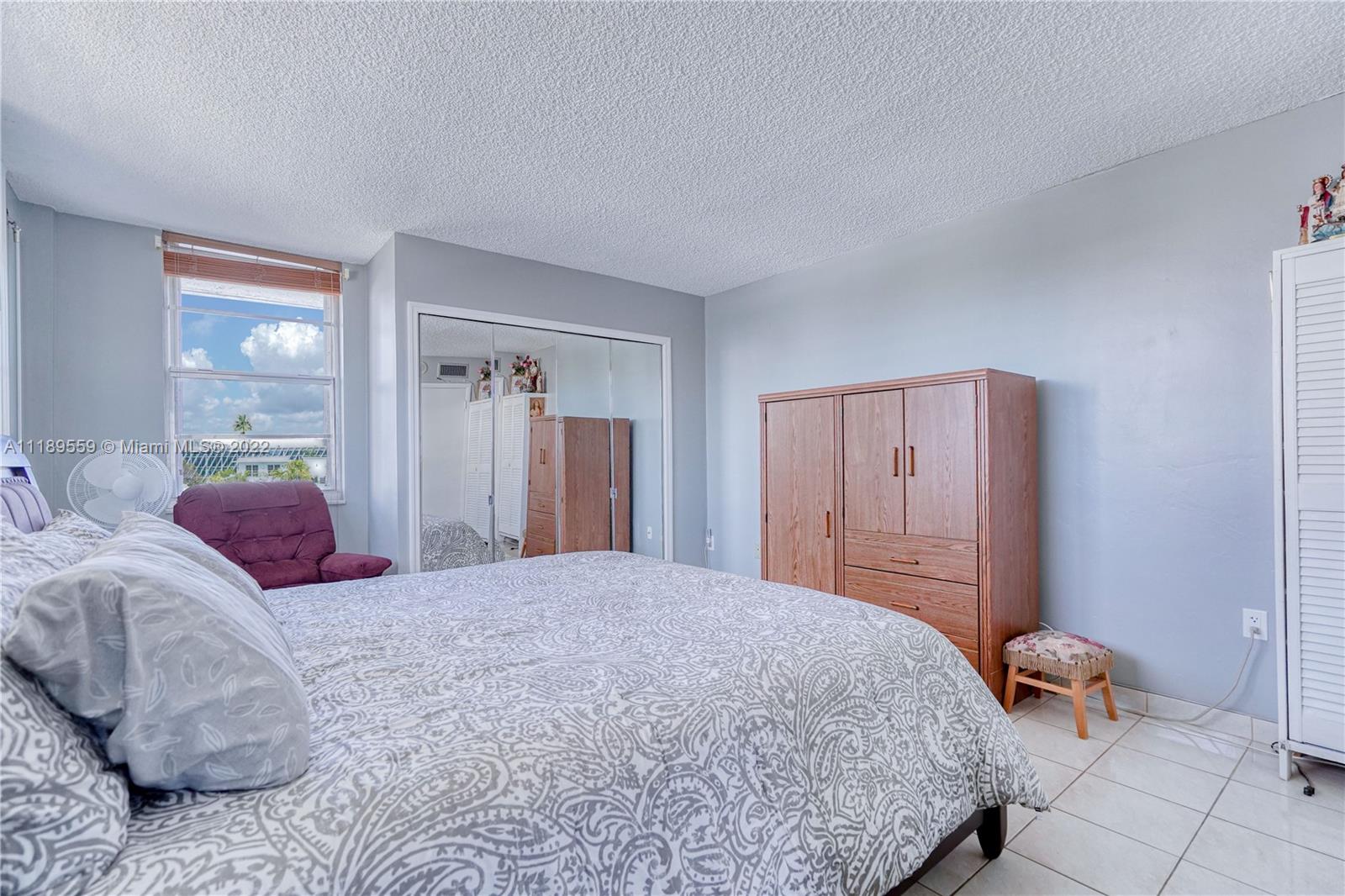 245 18th Street, Unit 602 Miami Beach, FL 33139 - Photo 16 of 40 a bedroom with a bed and a dresser