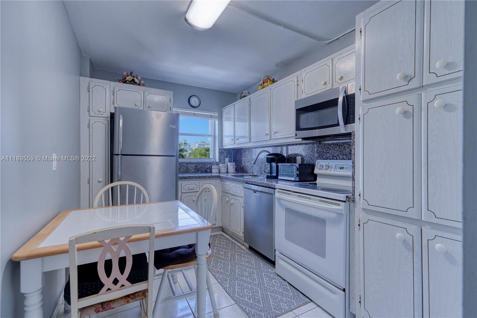 245 18th Street, Unit 602 Miami Beach, FL 33139 - Photo 18 of 40 a kitchen with stainless steel appliances granite countertop a sink refrigerator and cabinets