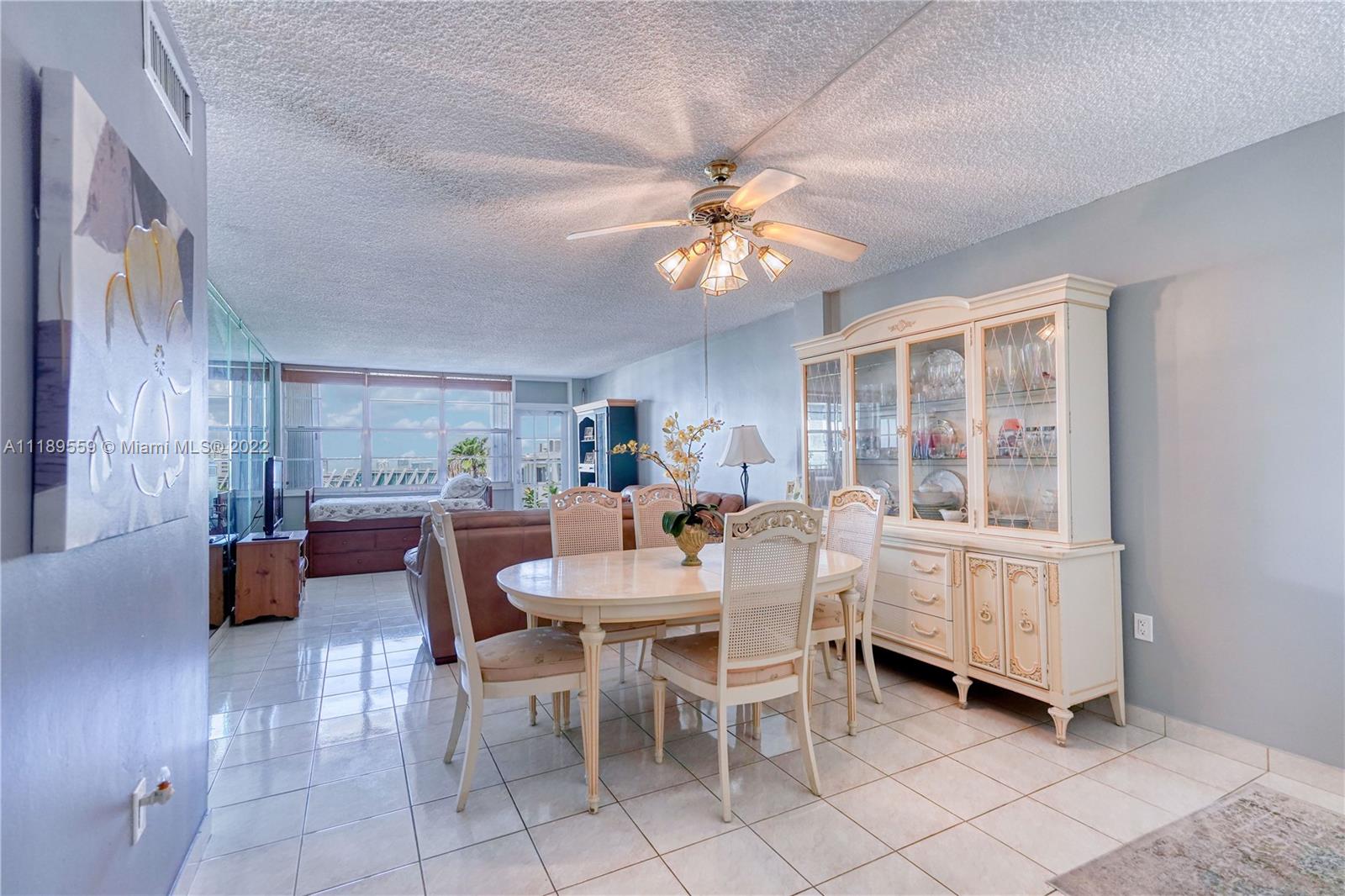 245 18th Street, Unit 602 Miami Beach, FL 33139 - Photo 9 of 40 a view of a dining room with furniture window and wooden floor