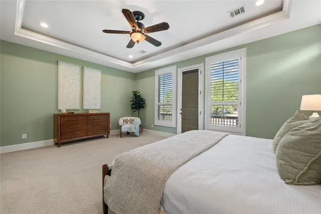 a bedroom with bed and a large window