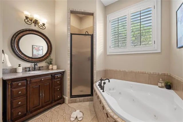 a bathroom with a tub sink and mirror