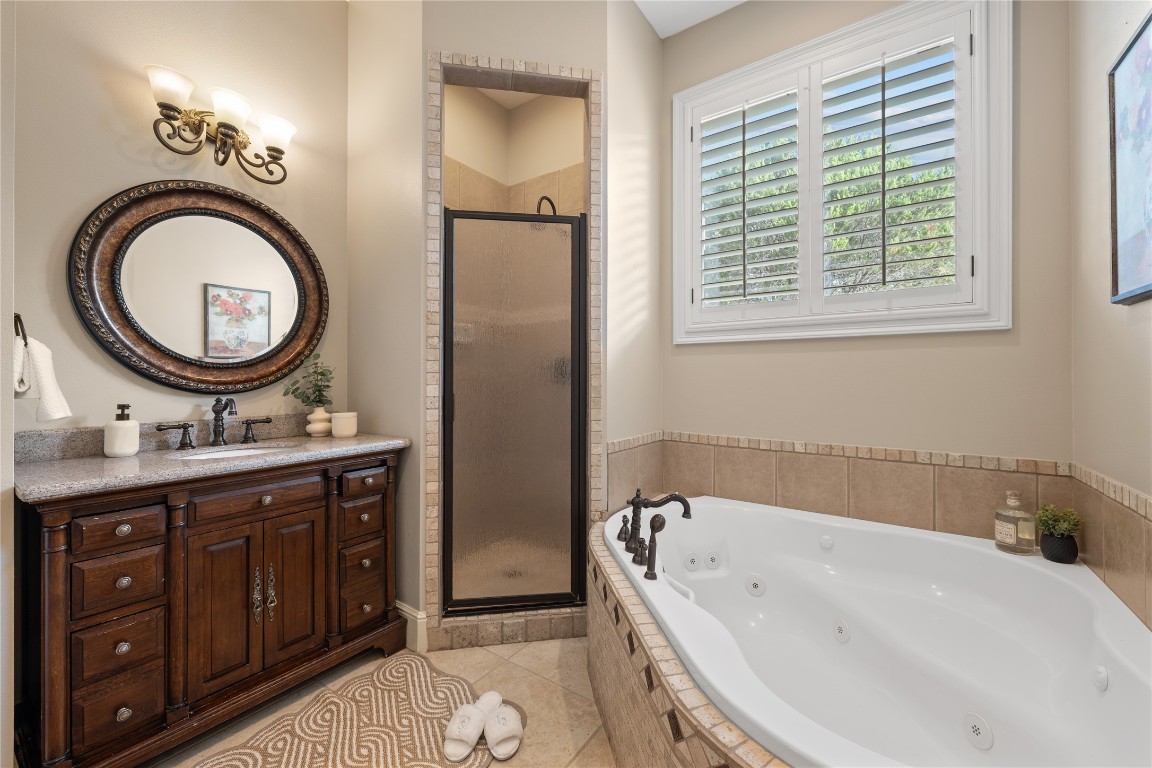 3507 Bachelor Gulch Leander, TX 78641 - Photo 19 of 38 a bathroom with a tub sink and mirror
