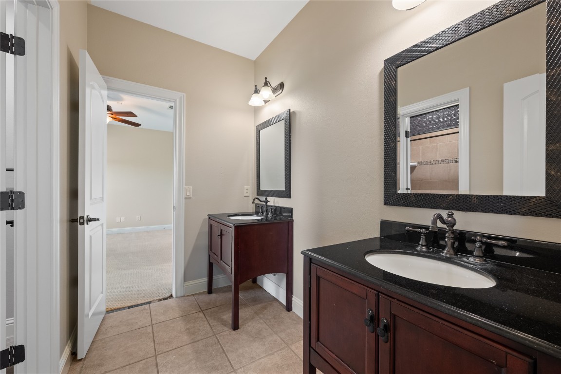 3507 Bachelor Gulch Leander, TX 78641 - Photo 21 of 38 a bathroom with a granite countertop sink and a mirror