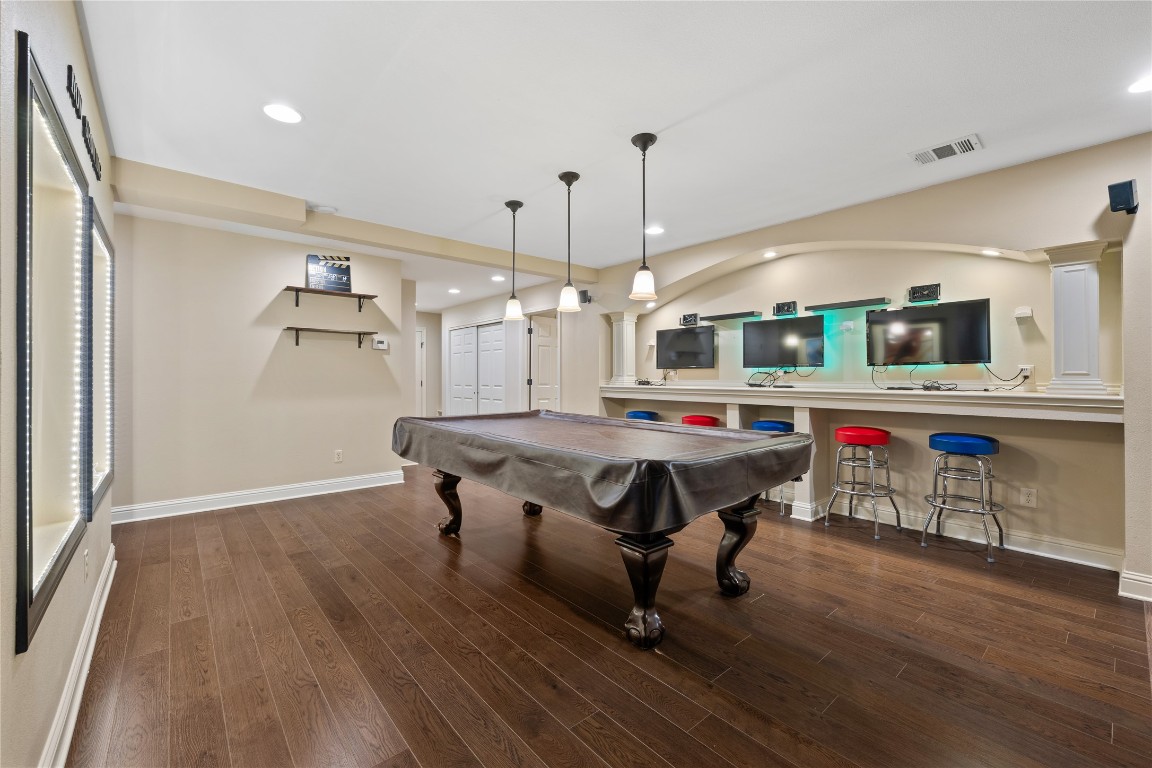 3507 Bachelor Gulch Leander, TX 78641 - Photo 25 of 38 a room with stainless steel appliances kitchen island granite countertop furniture and wooden floor