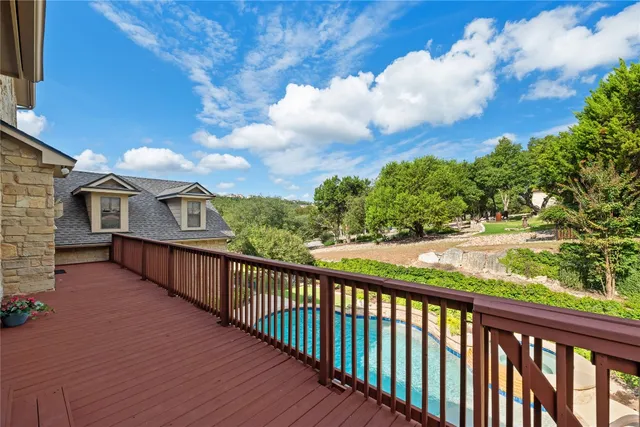 a view of a balcony with wooden fence