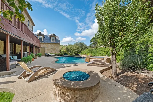 a view of a patio with furniture and a yard