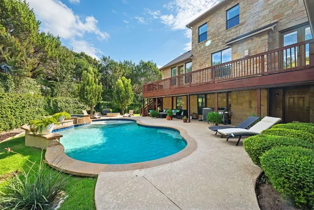 a view of a house with swimming pool and sitting area