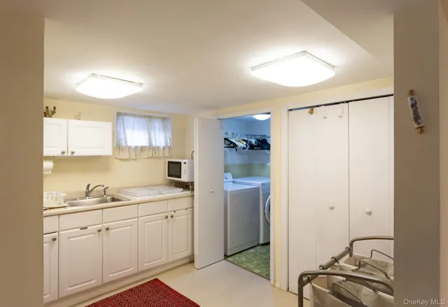 a view of a kitchen with sink a fireplace and windows