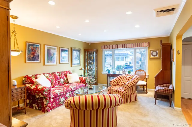 a bedroom with furniture and a large window