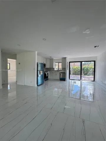 a view of empty room with furniture and floor to ceiling window