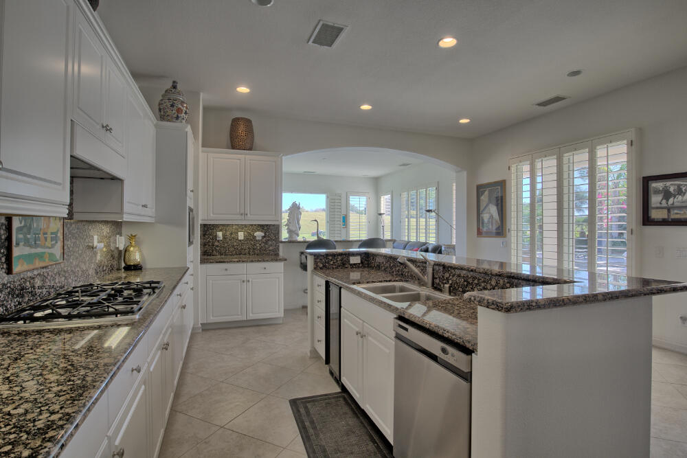 336 Loch Lomond Road Rancho Mirage, CA 92270 - Photo 13 of 26 a kitchen with stainless steel appliances granite countertop a sink and stove