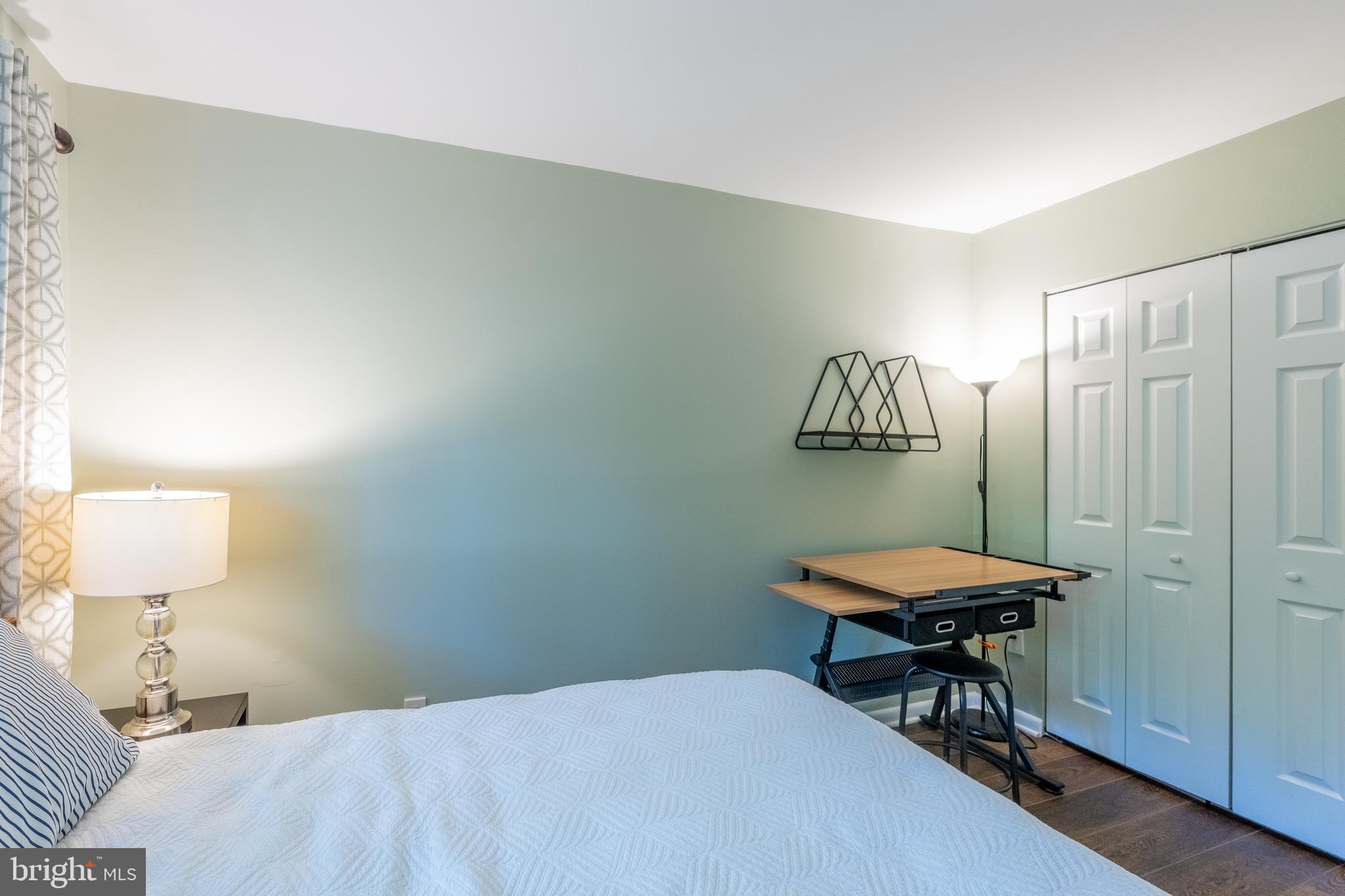 11917 Barrel Cooper Court Reston, VA 20191 - Photo 35 of 59 a bedroom with a bed and a table in it