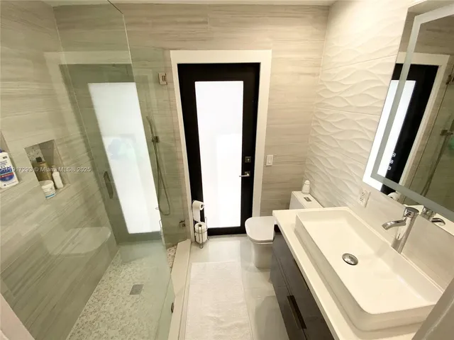 a bathroom with a tub sink and a mirror