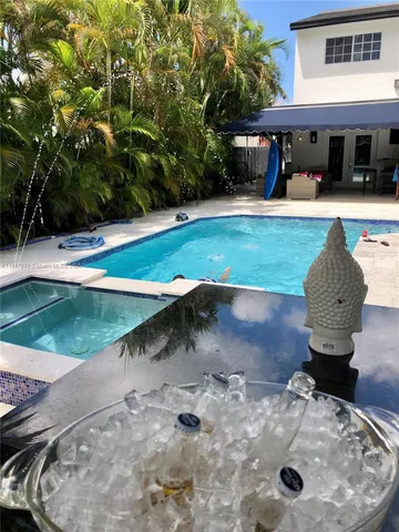 a view of a backyard with table and chairs with wooden fence