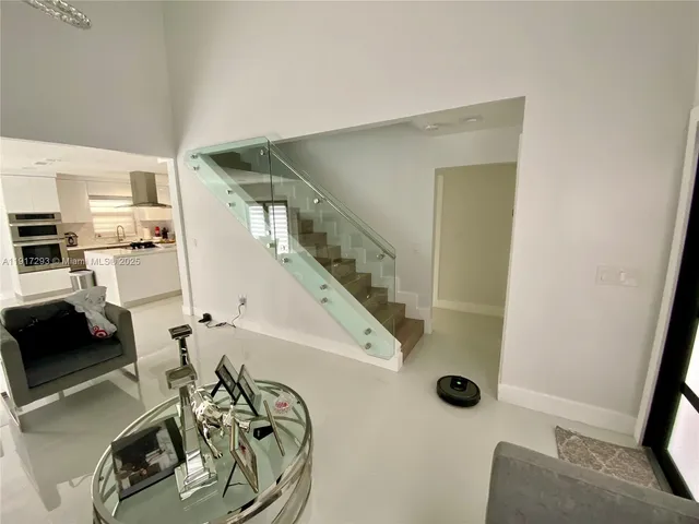 a view of a livingroom with furniture and white walls