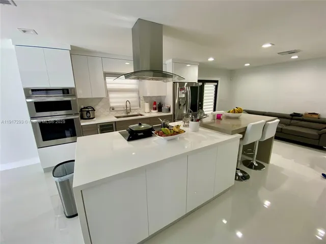 a kitchen with a stove a refrigerator and a sink
