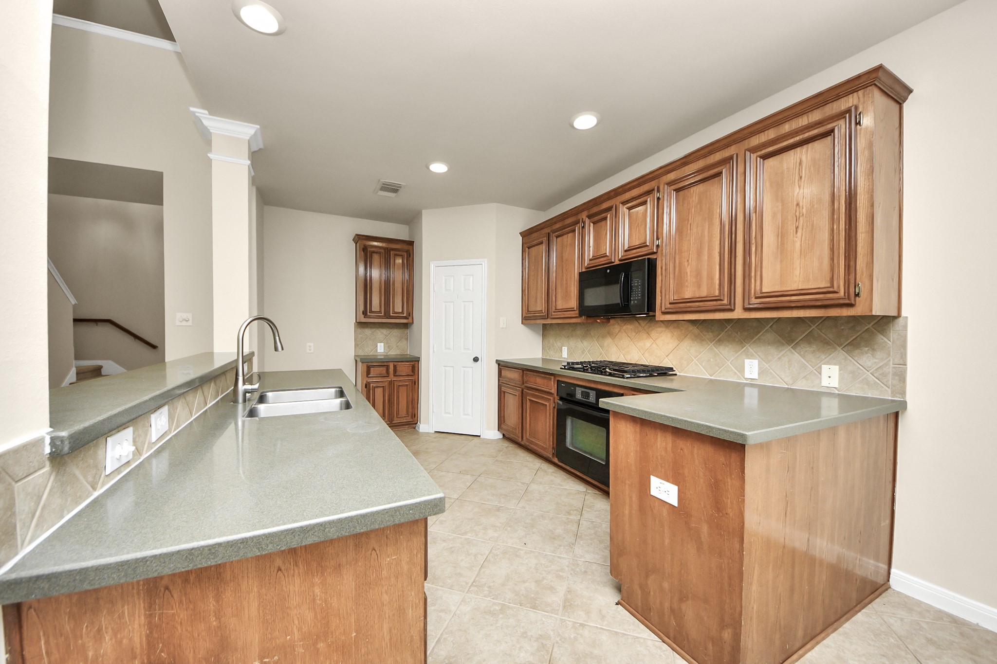 28306 Peper Hollow Lane Spring, TX 77386 - Photo 14 of 39 a kitchen with stainless steel appliances granite countertop a sink stove and microwave