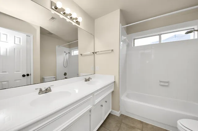 a bathroom with a tub sink and mirror