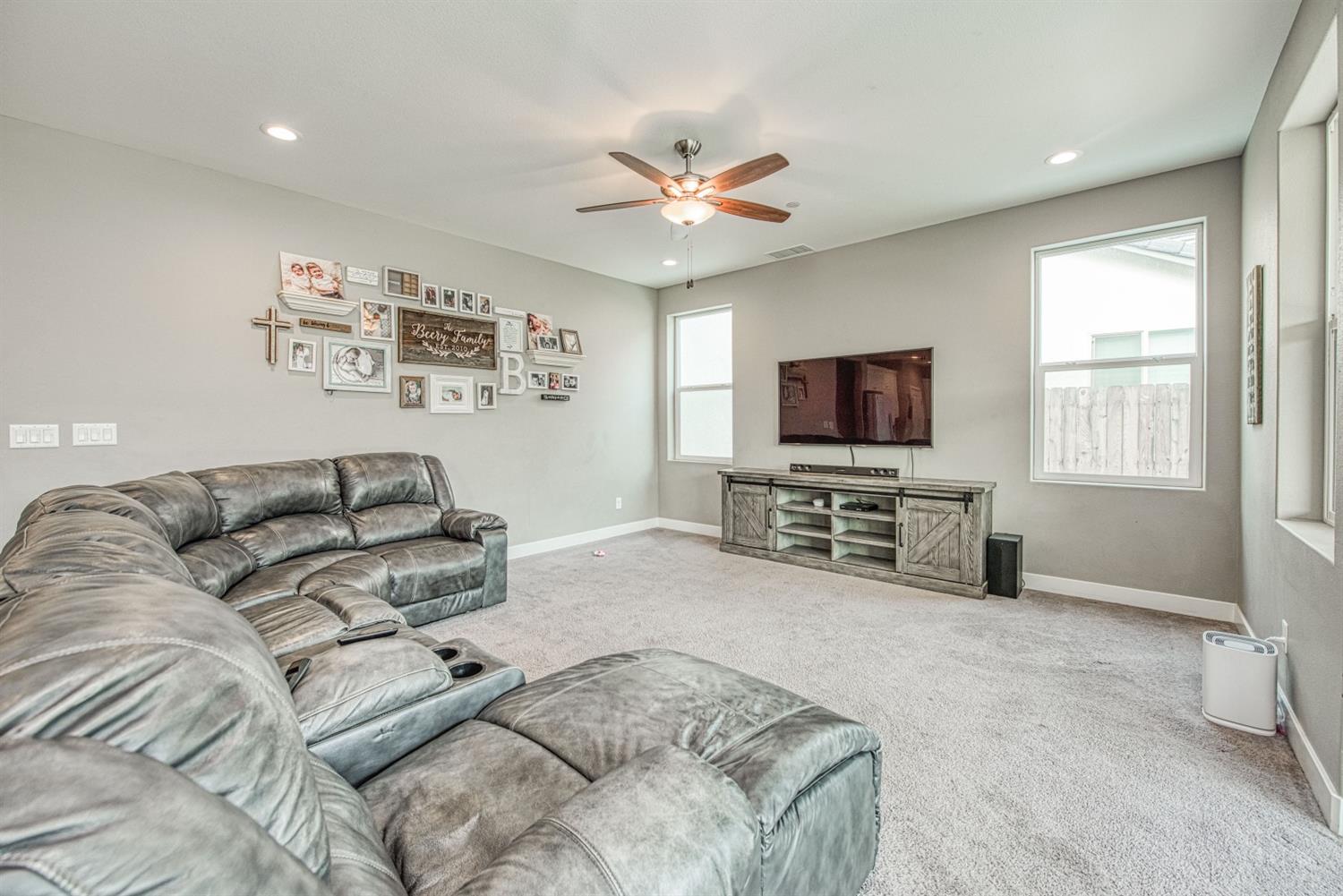 333 Meridian Avenue Madera, CA 93636 - Photo 12 of 38 a living room with furniture and a flat screen tv