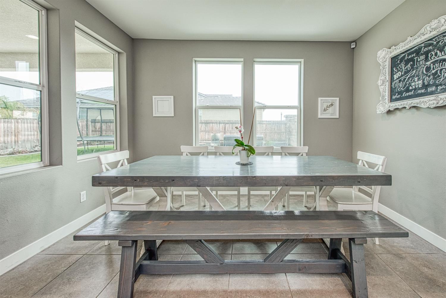 333 Meridian Avenue Madera, CA 93636 - Photo 15 of 38 a living room with a table and windows