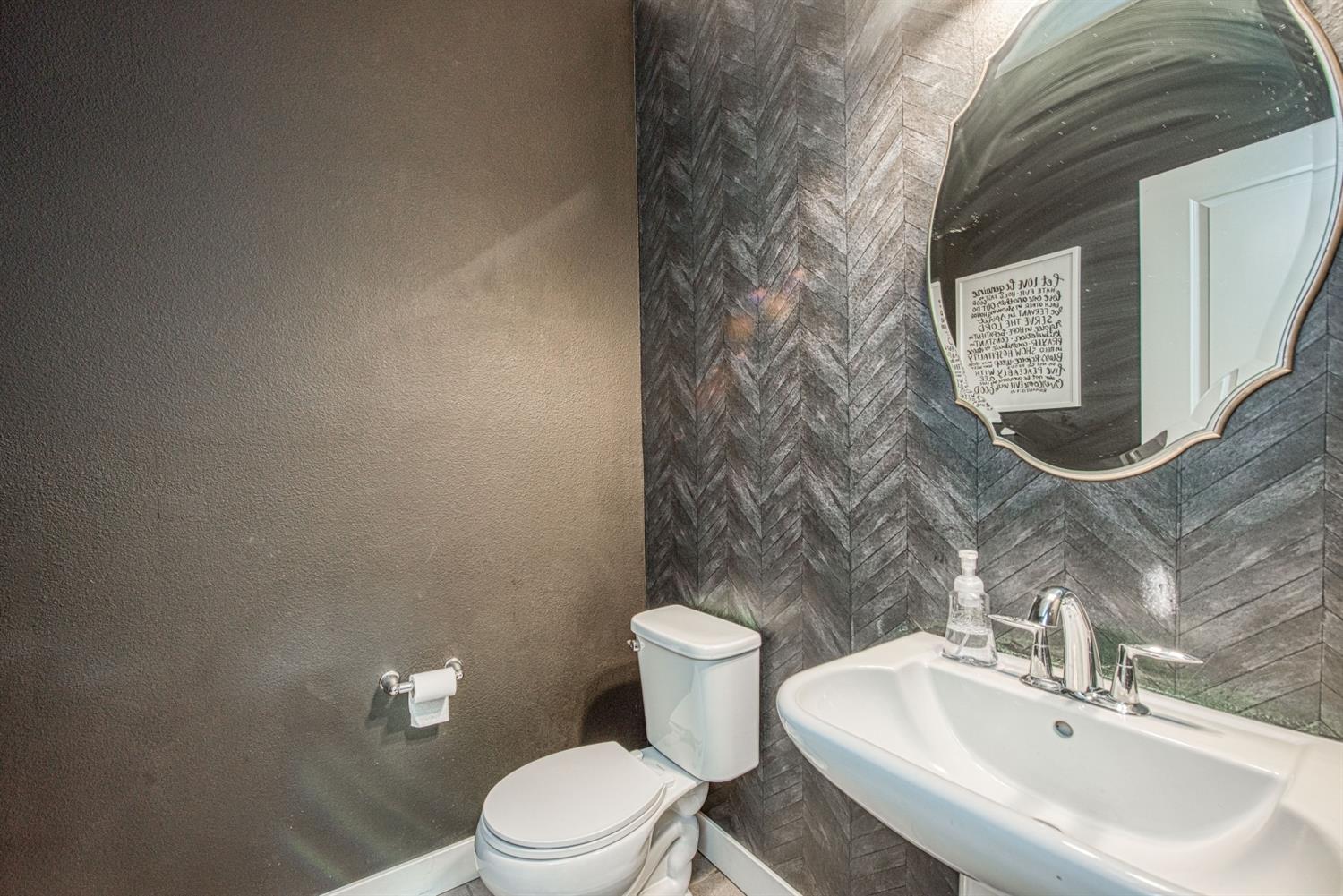 333 Meridian Avenue Madera, CA 93636 - Photo 16 of 38 a bathroom with a toilet sink and mirror