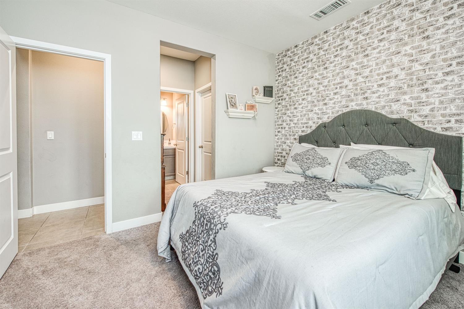 333 Meridian Avenue Madera, CA 93636 - Photo 18 of 38 a bedroom with a bed and a fireplace