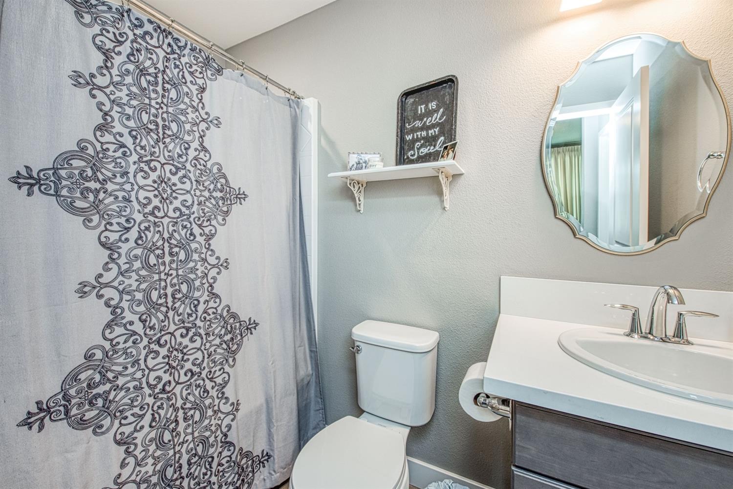 333 Meridian Avenue Madera, CA 93636 - Photo 20 of 38 a bathroom with a sink toilet and a mirror