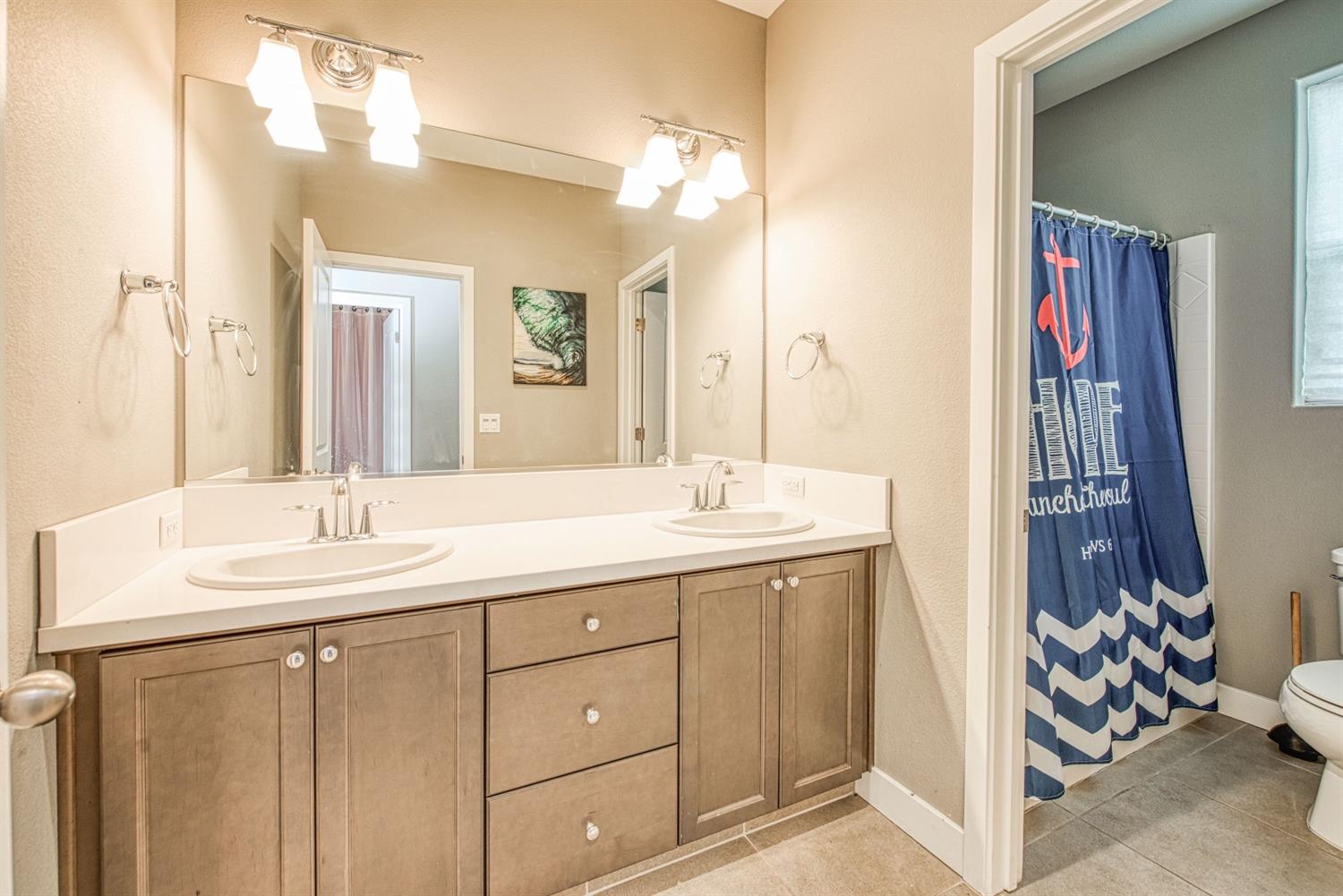 333 Meridian Avenue Madera, CA 93636 - Photo 26 of 38 a en suite bathroom with a double vanity sink and a mirror