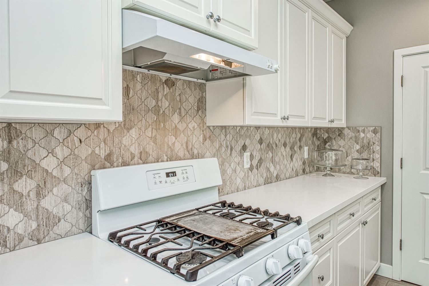 333 Meridian Avenue Madera, CA 93636 - Photo 8 of 38 a kitchen with a stove and a refrigerator