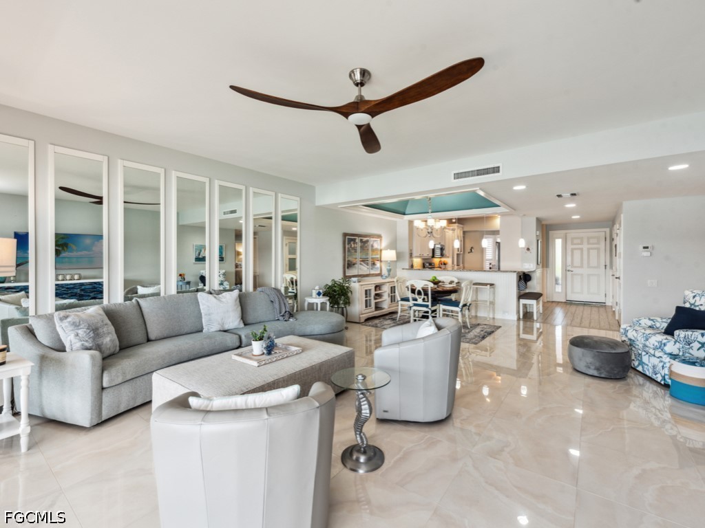 232 La Peninsula Boulevard, Unit 232 Naples, FL 34113 - Photo 14 of 44 a living room with furniture and a large window