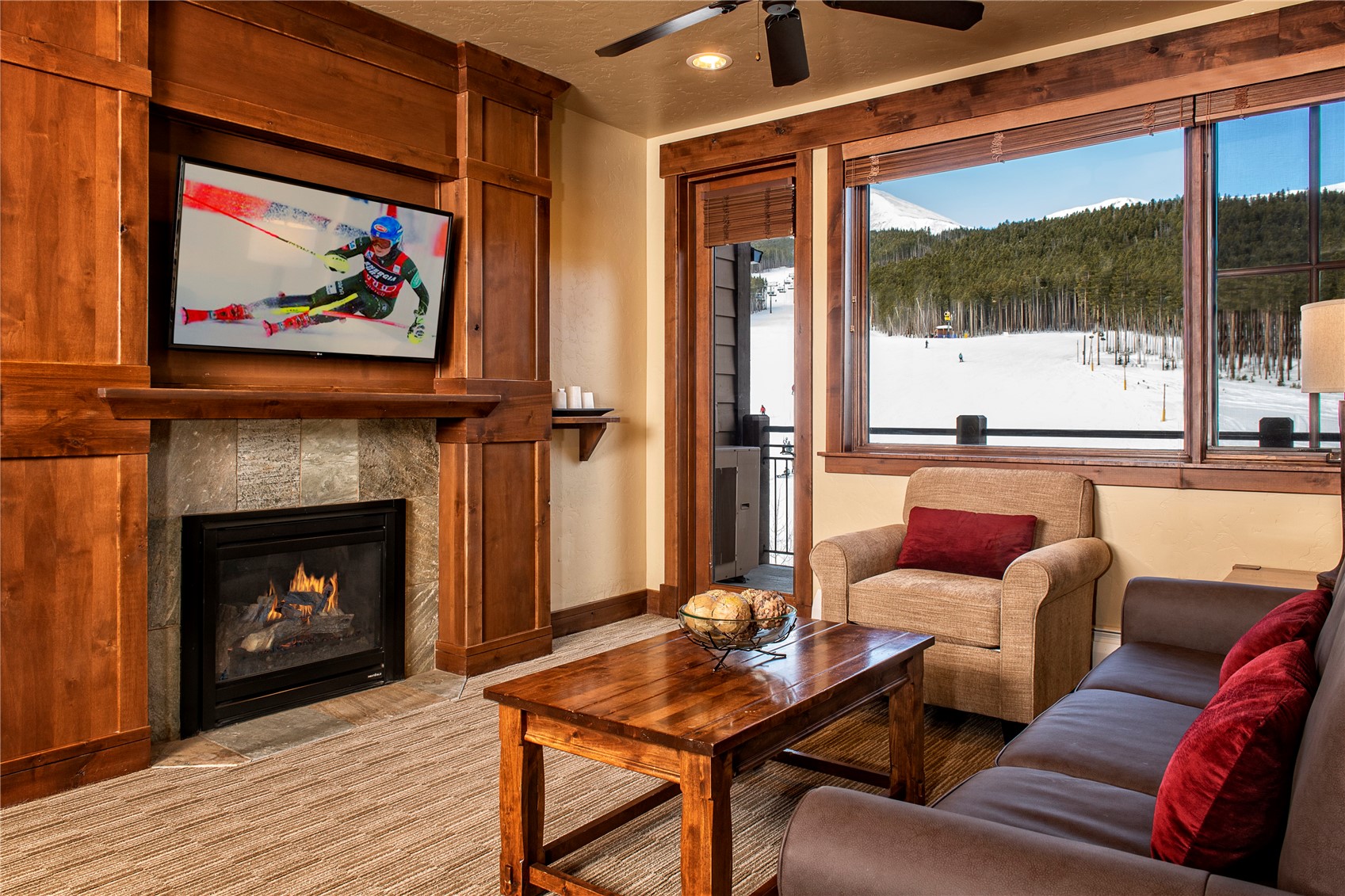 1979 Ski Hill Road, Unit COLORADO Breckenridge, CO 80424 - Photo 14 of 15 Living area with ceiling fan and a tile fireplace