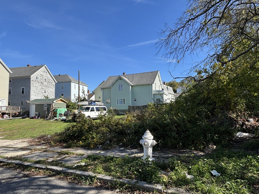 11 Dyer Street Fall River, MA 02720 - Photo 2 of 3 a front view of a house with a yard and street view