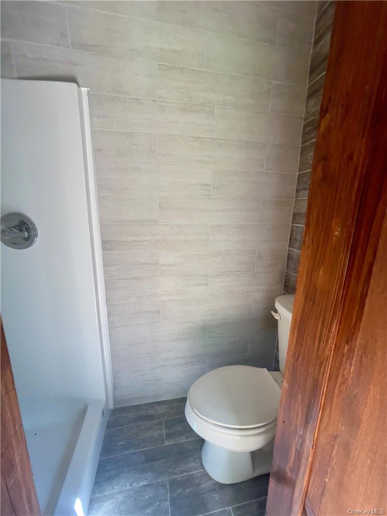 4 Old Turnpike Road Bloomingburg, NY 12721 - Photo 26 of 27 Bathroom with tile flooring, toilet, and tile walls