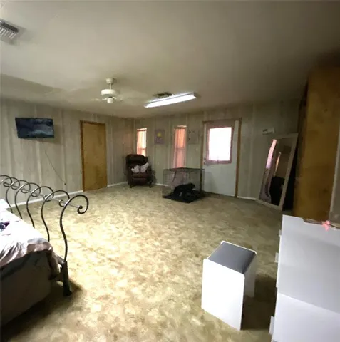 a view of a livingroom with furniture and a flat screen tv