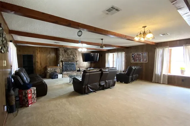 a living room with furniture gym equipment and a large window