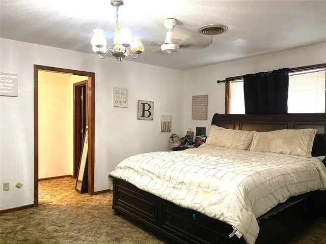 a bedroom with a bed and a chandelier
