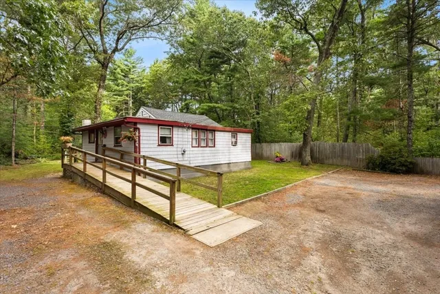 a view of a house with a yard and fence