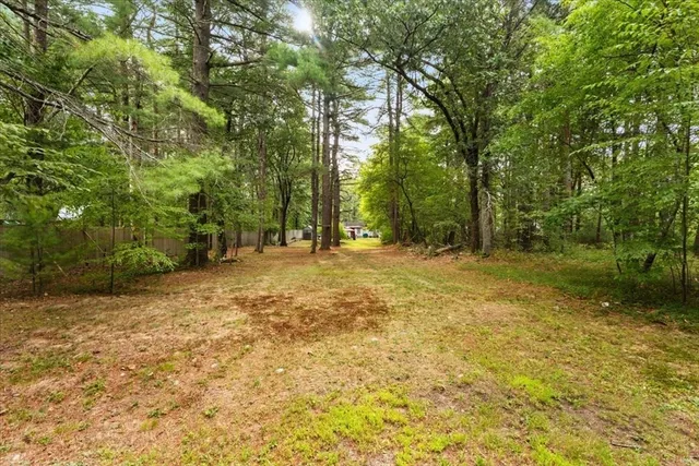 a view of a yard with swimming pool
