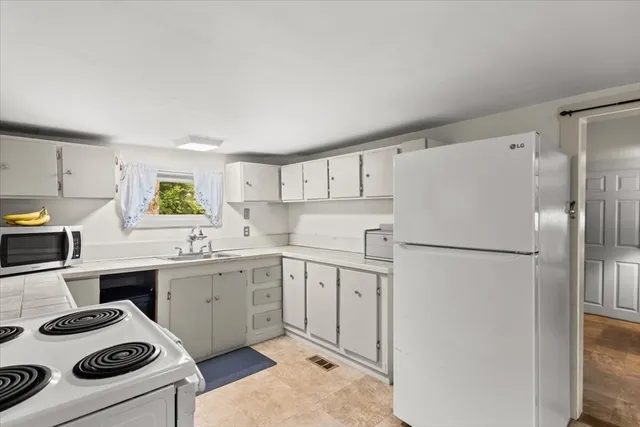 a kitchen with a refrigerator a stove and a refrigerator