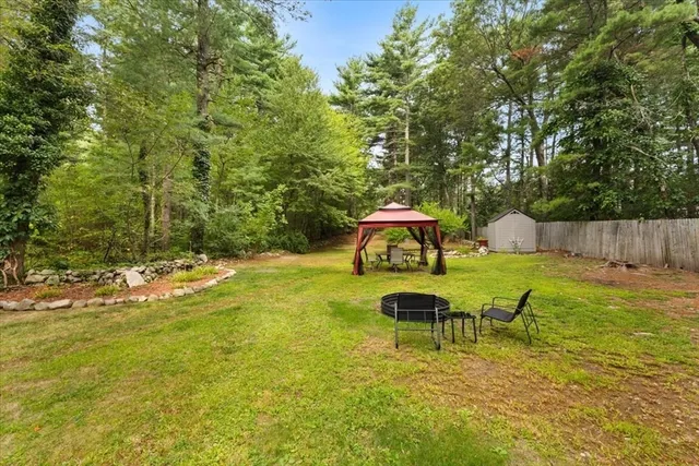 a backyard of a house with table and chairs