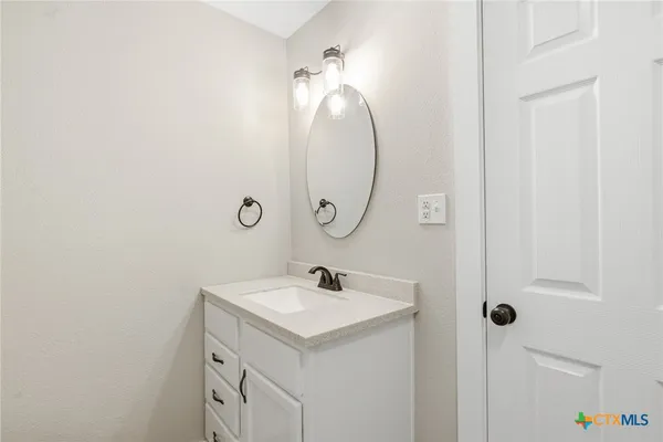a bathroom with a sink and mirror
