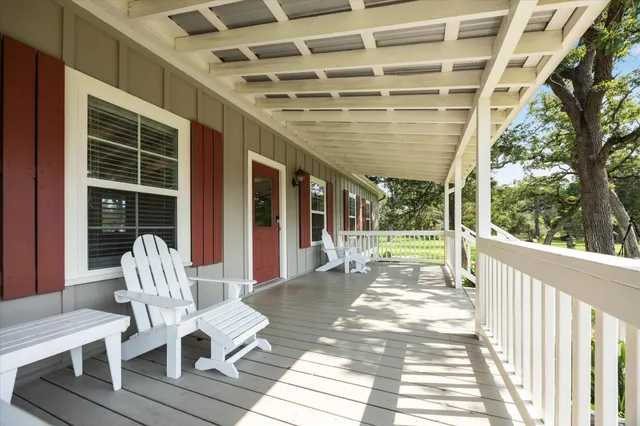 a view of a porch with furniture and a yard