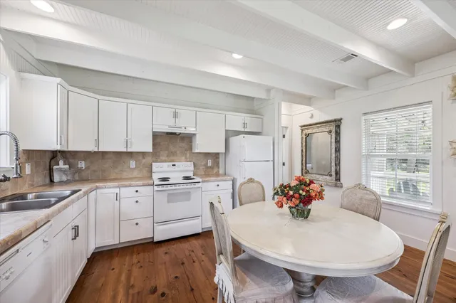 a kitchen with white cabinets and white appliances